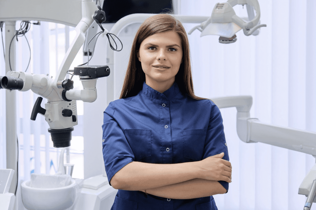 dentist posing in front of dental chair